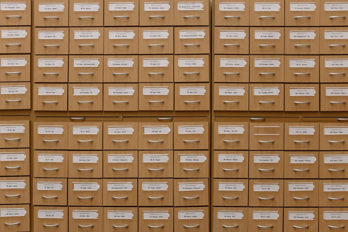 Rows of small labeled wooden drawers in a card-catalog cabinet
